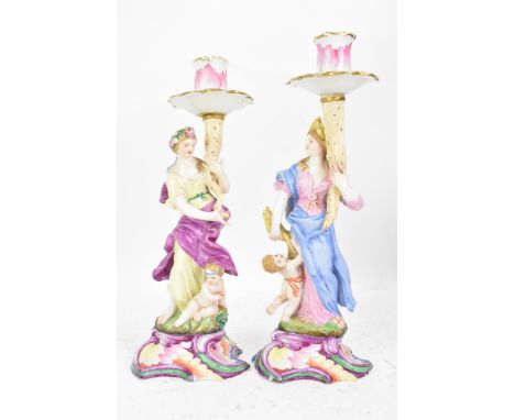 Two 19th century Capodimonte porcelain figural candlesticks, each painted in polychrome enamels, each modelled as a maiden in