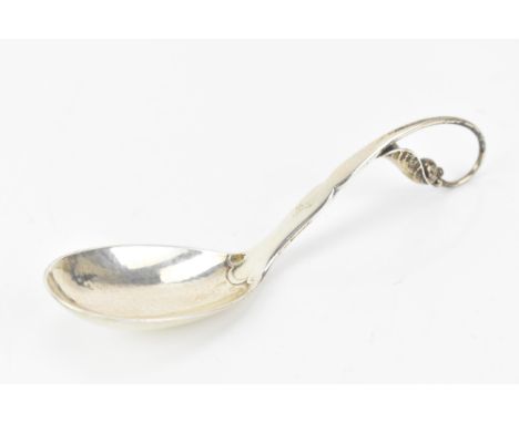 A 1930's Georg Jensen 925 silver caddy spoon, import marks for London 1930, having a stylised scrolled leaf formed handle, 13