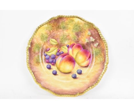 A Royal Worcester fruit decorated cabinet plate, of shaped circular form, hand painted with still lives of fruit and signed R