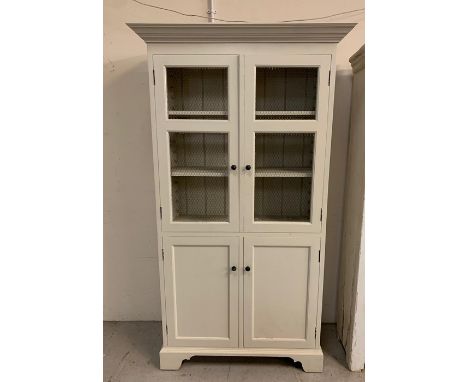 A painted display cabinet with chicken wire front on bracket feet (H207cm W115cm D46cm)