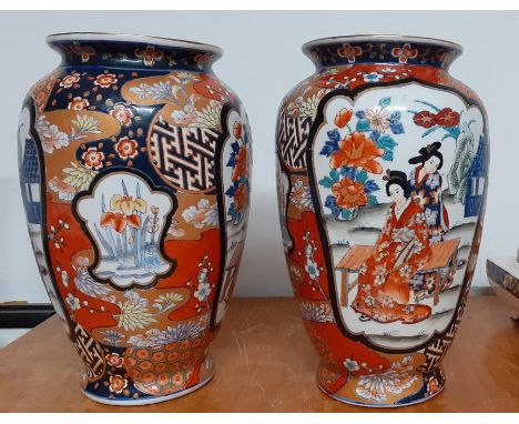 A pair of old Japanese Imari Vases, decorated with two feminine figures, with mark on the base (30 cm hight). (2)