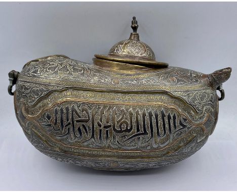 An Antique heavily engraved Persian camel flask.