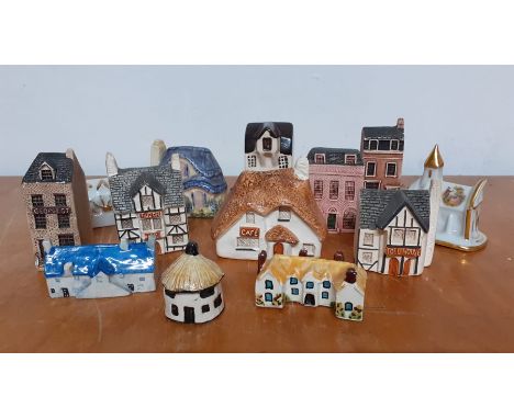 A collection of thirteen collectable miniature ceramic and pottery hand painted houses, made in England, (13).