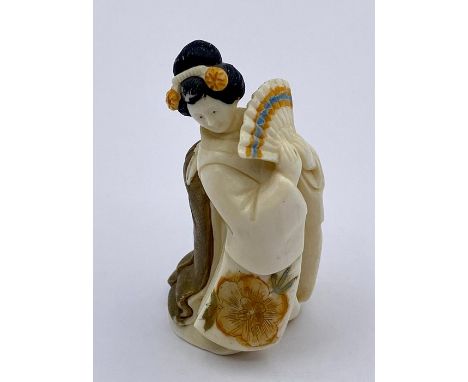 Signed Netsuke of a woman holding a fan, signed