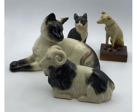 A vintage Siamese cat by Beswick and three more porcelain pets, (12x19 cm cat). (4)