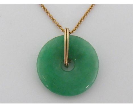 A jade bi necklace, the disc 20.8mm diameter, on a 9 carat gold fine link chain, the chain 18cm long, 4.3gms

