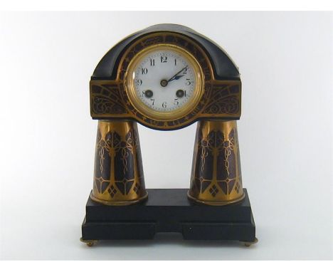 A fine example of a mantel clock in the Egyptian architectural manner, the ebonised base supporting the massive tapering colu