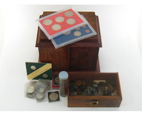 A walnut collector’s cabinet of architectural form, the lockable inlaid front doors, key missing, opening to reveal two drawe