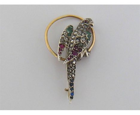 A late Victorian diamond, ruby, sapphire and emerald parrot brooch, circa 1880, pave set overall with rose cut diamonds, with