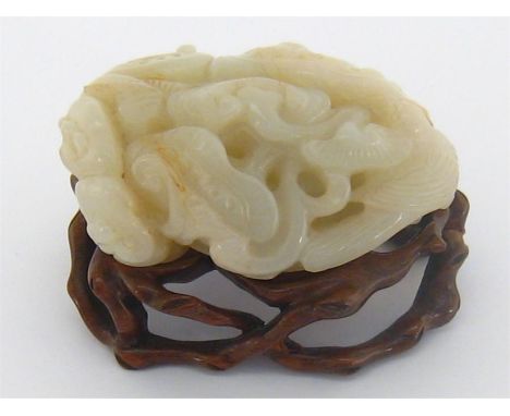A Chinese Q’ing dynasty carved He-tian white jade of a ling-zhi plant, 6.5x 4.5cm. on carved naturalistic stand. Condition re