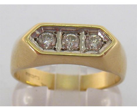 A 9 carat gold and three stone diamond ring, the three uniform brilliants mounted within a white gold trough setting, totalli