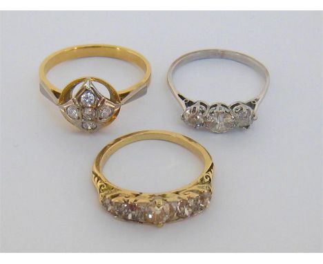 Three diamond set rings, including a late 19th century five stone diamond ring, set with five graduated old cuts, the yellow 