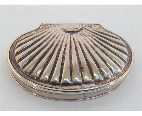 A George I silver snuff box of scalloped form, maker’s mark indistinct, London, 1716, with leafy scroll engraving above the h