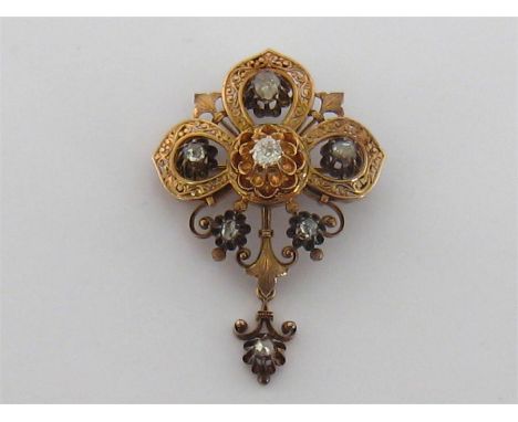 A late 19th century (possibly French) gold and diamond brooch/pendant, the finely chased and pierced quatrefoil mount set to 