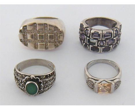A mixed lot of silver (stamped 925) rings, including an amethyst set example, finger size O; a large paste set example, finge