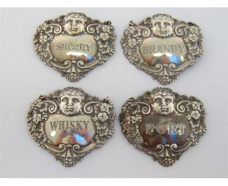 Four silver decanter labels by Turner & Simpson Ltd., Birmingham, one 1956, three 1957, of escutcheon form after early 19th c