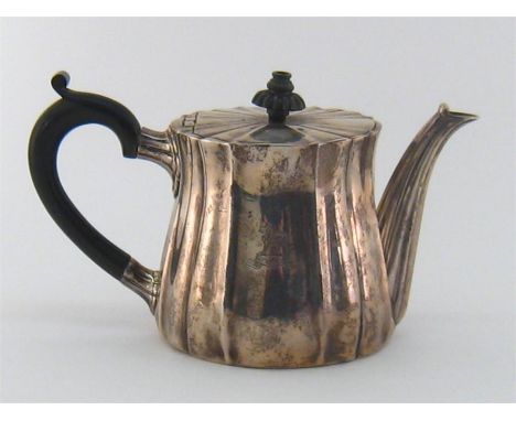 A Victorian silver teapot by Robert Garrard, London, 1877, of fluted and waisted cylindrical form, ebonised handle and finial
