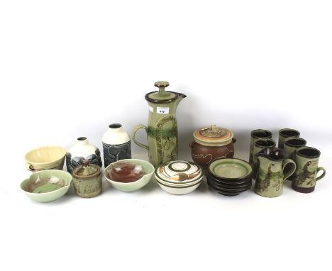 An assortment of studio pottery. Including a green glazed coffee pot and six saucers, lidded pots, etc, some signed