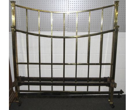 A 20th century double bed frame on ceramic casters. Brass bed ends with iron stretcher, L173cm x D138cm x H143cm