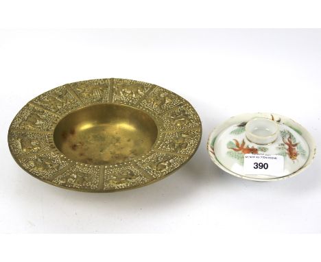 An oriental brass bowl and other items. The first painted gold, together with a ceramic tea cup and lid with fish decoration,