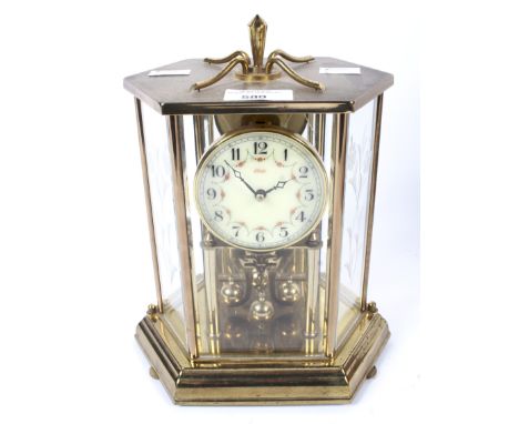 A West German Kundo Torsion Anniversary brass mantel clock. A cream coloured dial with Arabic numbers and flower swag decorat