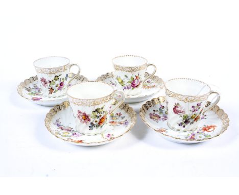 Four 20th century Dresden porcelain spiral-moulded tea cups and saucers. Painted with flowers, below gilt borders 