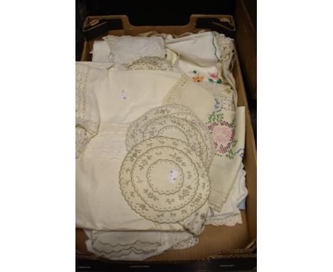 An assortment of mixed vintage table linen, including embroidered tray clothes and crotched edged examples.