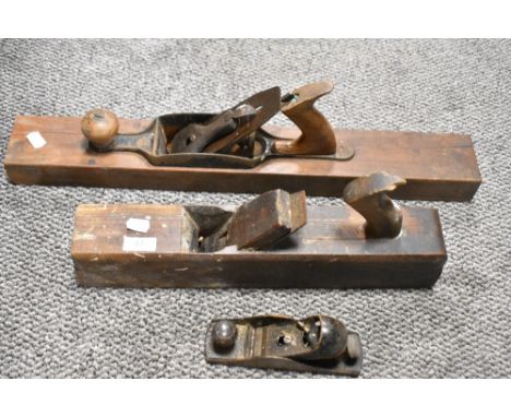 Two vintage Jack planes and a smaller Stanley plane.