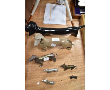 Seven Dachshund studies, including Spanish made Lladro style ceramic study and cast metal examples.