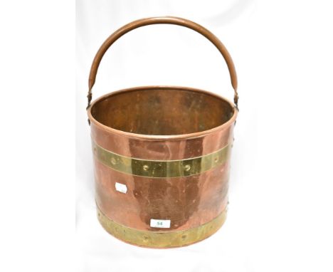 A vintage brass and copper coal bucket.