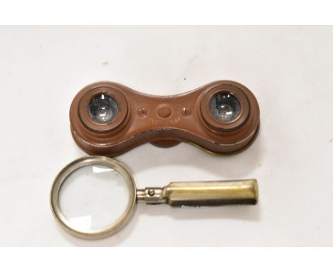 A set of compact vintage 'Vestocular' binoculars and a folding magnifying glass.