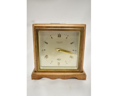 A mid century wood and brass cased mantel clock, having bevelled glass to front, An Elliot clock, H Little &amp; Sons, Lancas