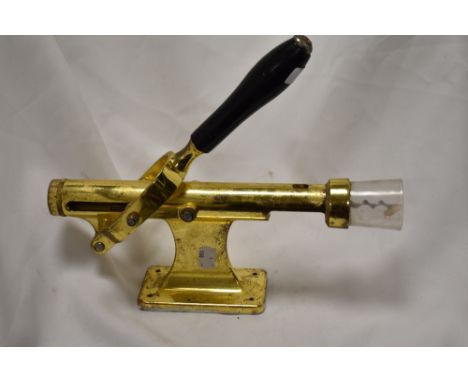 A vintage wall mounted cork screw.