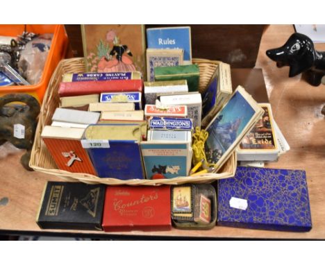A basket of vintage playing cards, card games and counters.