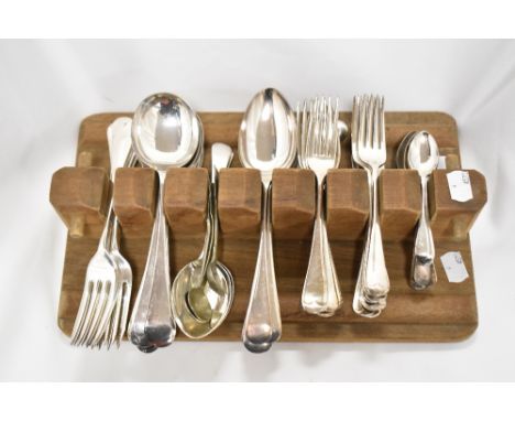 A selection of plated cutlery in vintage wooden holder.