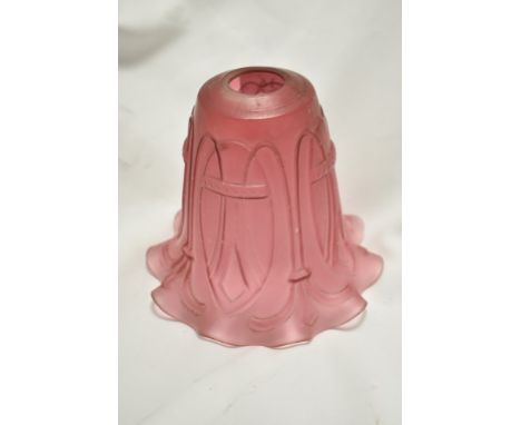 A late 19th/ early 20th century cranberry glass lamp shade, of fluted form, having Macintosh style embossed design to body.