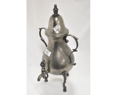 An early 20th century pewter samovar tea pot in a Gothic design on tripod base.