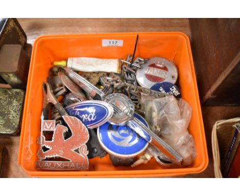 A box of vintage car boot and bonnet badges and similar items, including Morris, Ford and Vauxhall.