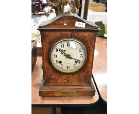An early 20th century bracket style mantel clock of military interest with oak case and presentation plaque for Cpt Cook of t