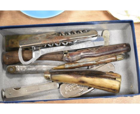 A selection of vintage knives and bottle openers, including horn handled and advertising examples for Booths dry gin, Carlsbe