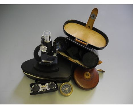 A set of binoculars, tape measure and compass.