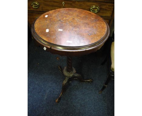 A Victorian walnut veneered cuticular lamp table on turned pedestal and tri form support.