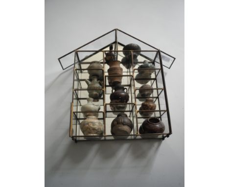 A collection of early English pottery miniature ceramic vases.