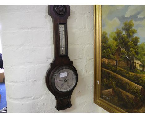An oak cased wall barometer together with three wall mirrors.