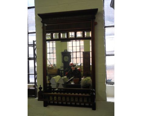 An Edwardian mahogany framed wall mirror with gallery shelf.