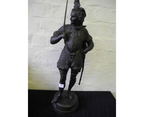 A metal table lamp in the form of a Spanish gentleman with sword.