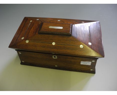 A rosewood tea caddy with inlaid mother of pearl decoration.
