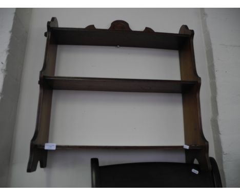 An Edwardian mahogany wall mounted book shelf.