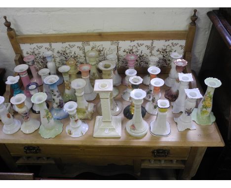 A large selection of ceramic candlesticks.