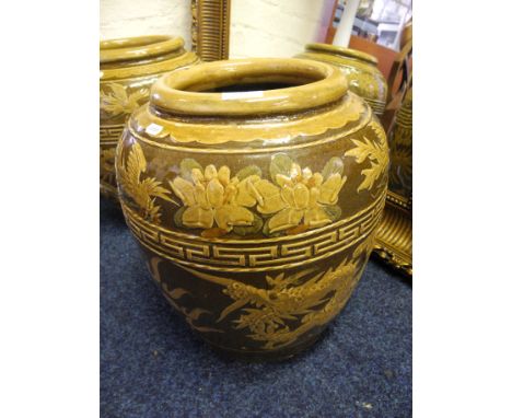 Two large green glazed ceramic pots with oriental dragon decoration.